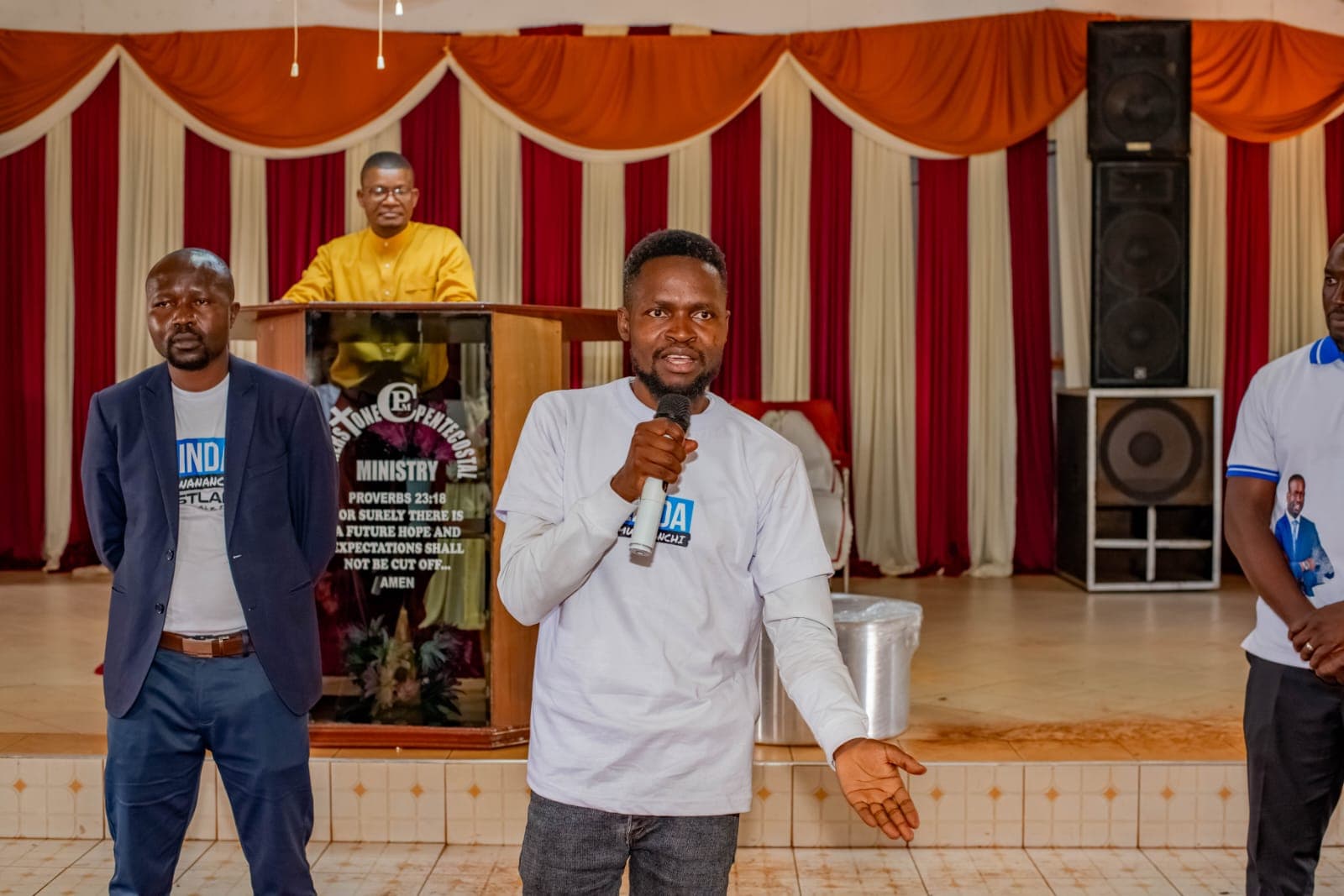 Oburenyi Harrison speaking to residents at a community gathering