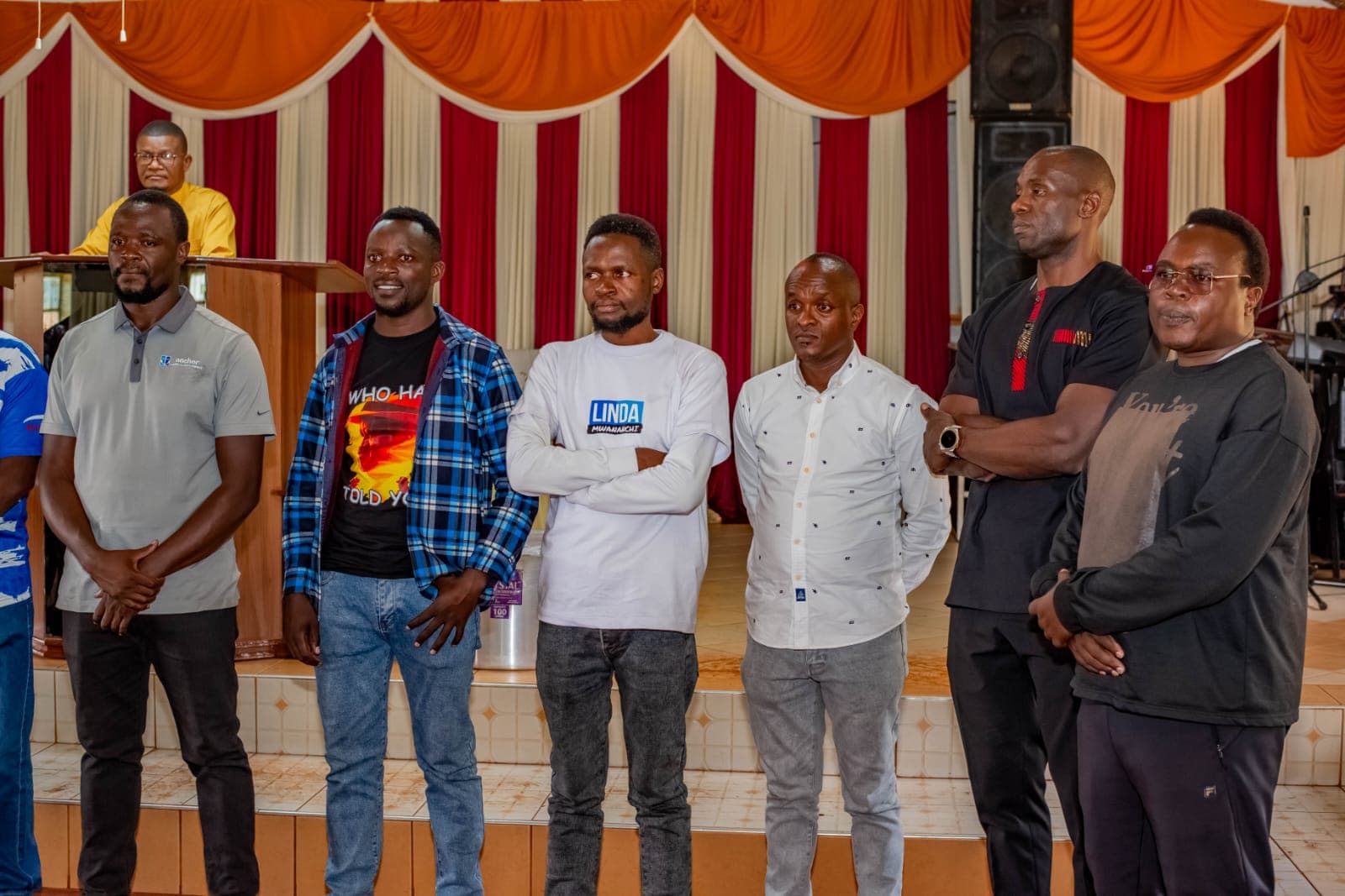 Oburenyi Harrison standing with community leaders
